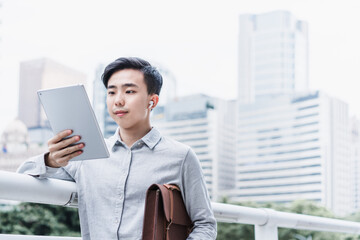 Business people using tablet computer outdoors