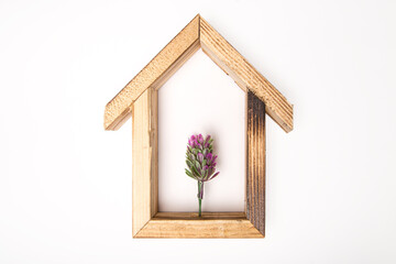 wooden hexagonal wall decorative  frame with an artificial flower in the center. on a white isolated background