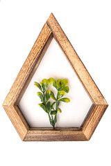 wooden hexagonal wall decorative  frame with an artificial flower in the center. on a white isolated background