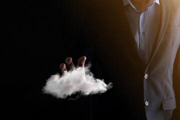 Businessman hand holding cloud.Cloud computing concept, close up of young business man with cloud over his hand.The concept of cloud service.
