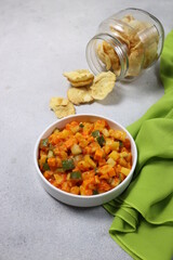 Acar. Acar is a pickles sliced mix of vegetable pickle made of cucumber,carrot and pineapple in vinegar