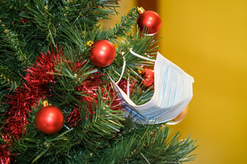 Protective surgical Face mask on christmas tree decoration,covid19 pandemic disease