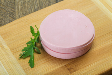 Sliced sausage over the wooden board
