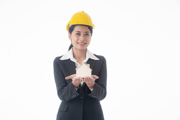 Young engineer woman wear black suit and yellow safety helmet holding small house model on isolated white background.