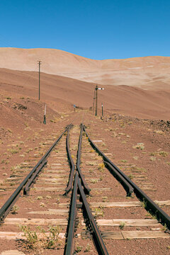 Railway tracks through desert landscape