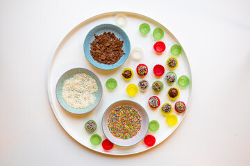 Traditional Austrian Christmas Truffles with Chocolate and Rum. Coated in coconut and sprinkles, handmade from scratch. in pretty colorful paper cups.