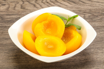 Sweet ripe canned peaches with mint