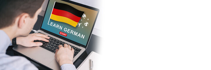 Man working on laptop with LEARN GERMAN on a screen. Education learning german language school...