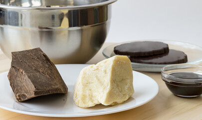 Ingredients for making homemade chocolate. Cocoa mass, cocoa butter, syrup