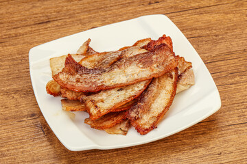 Roasted juicy bacon in the plate
