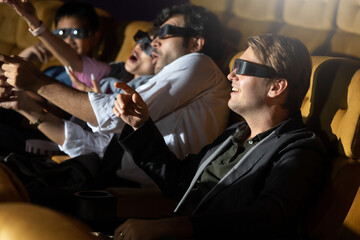 3D Movie. Group of diversity people in theater with popcorn and drinks.