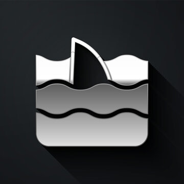 Silver Shark fin in ocean wave icon isolated on black background. Long shadow style. Vector.