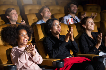 Group of diversity people watching movie in cinema theater with popcorn and drinks. Enjoy Happy laughing fun sad drama action movie concept.
