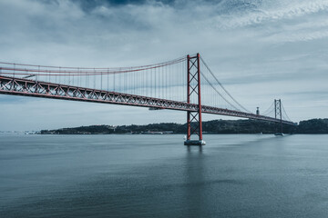 Fototapeta na wymiar Tejo River and the '25 of April' Bridge in Lisbon, Portugal, 