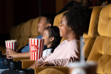 Happy family watching movie in cinema theatre. Happy family time in holiday