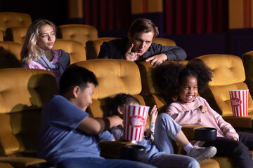 Happy family watching movie in cinema theatre. Happy family time in holiday