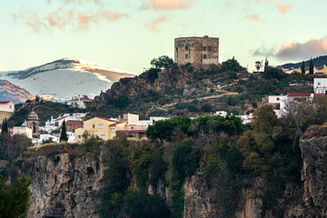 Fototapeta na wymiar Arab castle of the Ulloa in the town of Velez de Benaudalla with Sierra Nevada in the background.