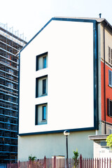 Blank billboard on building for outdoor advertising in Milano, Italy.