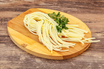 Chechil spaghetti cheese over board