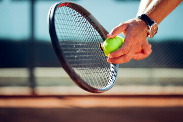 Tennis player's hand preparing to take a serve