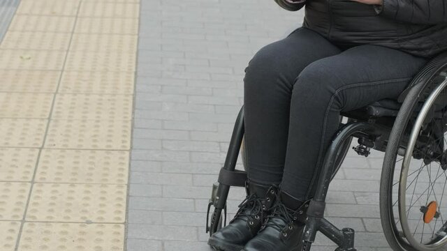 Disabled lady with a cell phone and a protective mask.