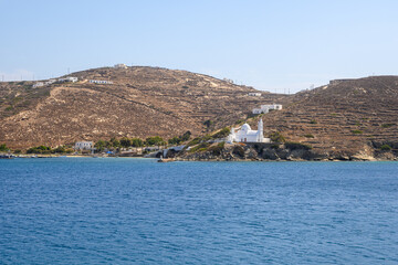 The port of Ios Island in Greece, a picturesque bay with a small settlement and characteristic church on the hill. Cyclades Islands, Greece