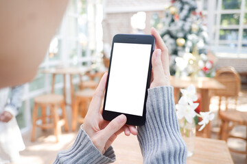 Cropped shot view of business woman’s hands holding the mobile phone with blank copy space screen for your information content or text message, the woman reading text message on the smart phone.