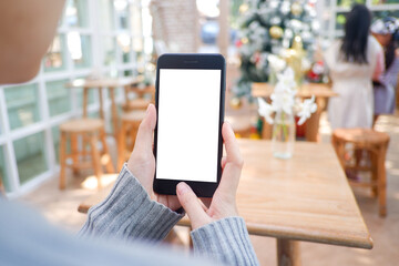 Cropped shot view of business woman’s hands holding the mobile phone with blank copy space screen for your information content or text message, the woman reading text message on the smart phone.