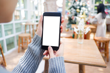 Cropped shot view of business woman’s hands holding the mobile phone with blank copy space screen for your information content or text message, the woman reading text message on the smart phone.