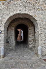 A narrow street among the old houses of Satriano di Lucania, a medieval village in the Basilicata region.