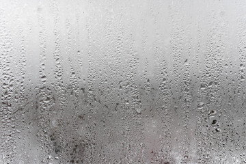Close up for misted glass with droplets of water draining down. Dripping Condensation, Water Drops Background Rain drop Condensation Texture
