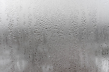 Close up for misted glass with droplets of water draining down. Dripping Condensation, Water Drops Background Rain drop Condensation Texture