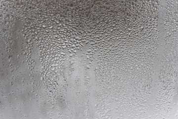 Close up for misted glass with droplets of water draining down. Dripping Condensation, Water Drops Background Rain drop Condensation Texture