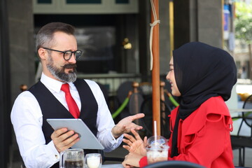 Arabic waiter team meeting and discussing over menu before opening the café in halal restaurant for Muslim culture