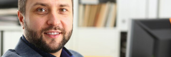 Delighted brunette businessman expressing positivity while looking at camera, going to work at his project