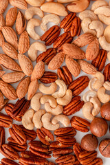 Proper nutrition composition of assorted nuts pattern vertical photo for banner, article or packaging.