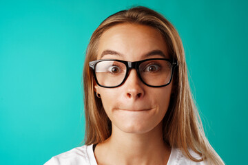 Fototapeta premium Shocked and amazed young blonde woman close up portrait.