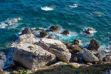 rock cliff top view with drone by the sea
