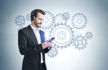 Man with smartphone and gears sketch