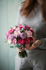 Beautiful bouquet in the hands of a young woman