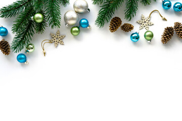 Holiday flat lay of decorations. Christmas toys, cones and fir branches on white background, space for text