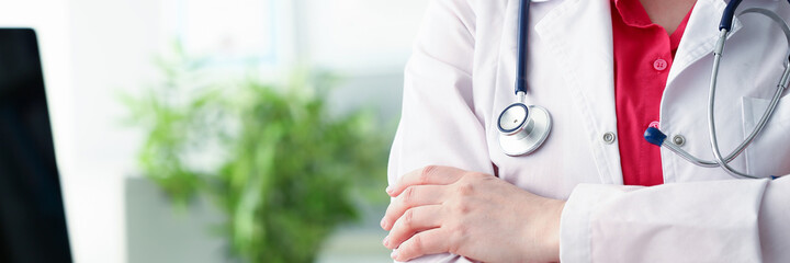 Fototapeta premium Kind female person keeping stethoscope on her neck while preparing for working day
