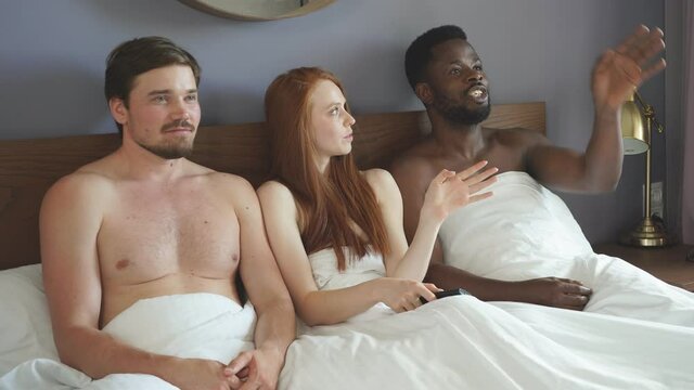 Ethnic group of friends watching movies on TV. Concept of free relationships