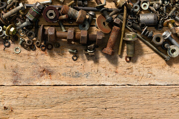 Fototapeta na wymiar old vintage hand tools - set of screws and nuts on a wooden background with blank space for text