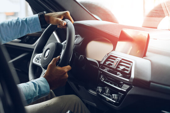 Male hands holding steering wheel of a car - Powered by Adobe