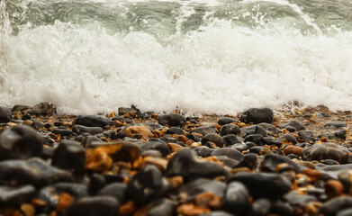 Obraz premium Pebbles and waves balance, Background.