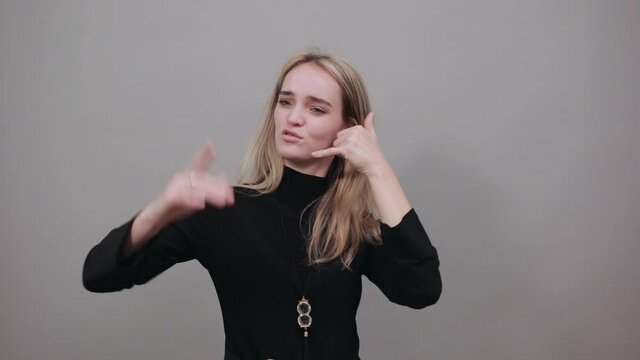 Imitates telephone conversation, keeps hand near ear as if holding mobile phone. Talking on smartphone simulates. Call with her finger. Asks to recall. Pretending that speaking with somebody
