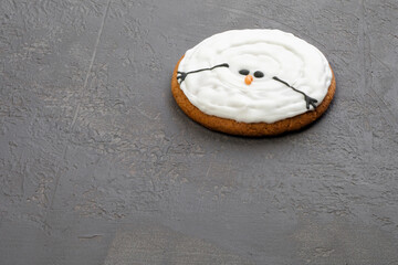 Melted Christmas cookies in the shape of a snowman, isolated on gray background