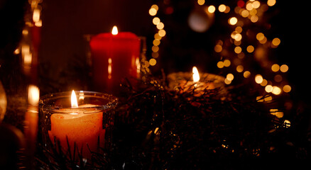 New Year's candles in Christmas trees with beautiful sides in the background in the New Year and Christmas