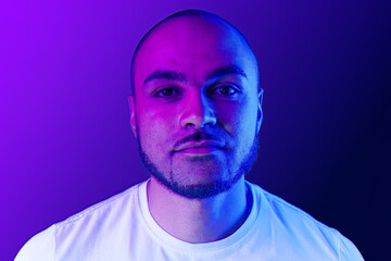 Close up portrait of a black man in purple neon light